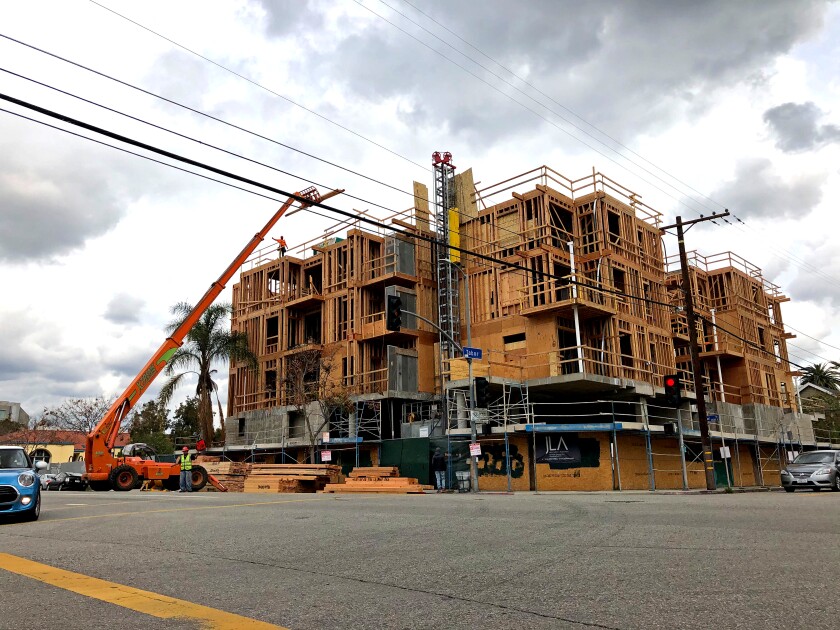 Construction workers on Friday were busy building an apartment complex in the Palms neighborhood of Los Angeles. 