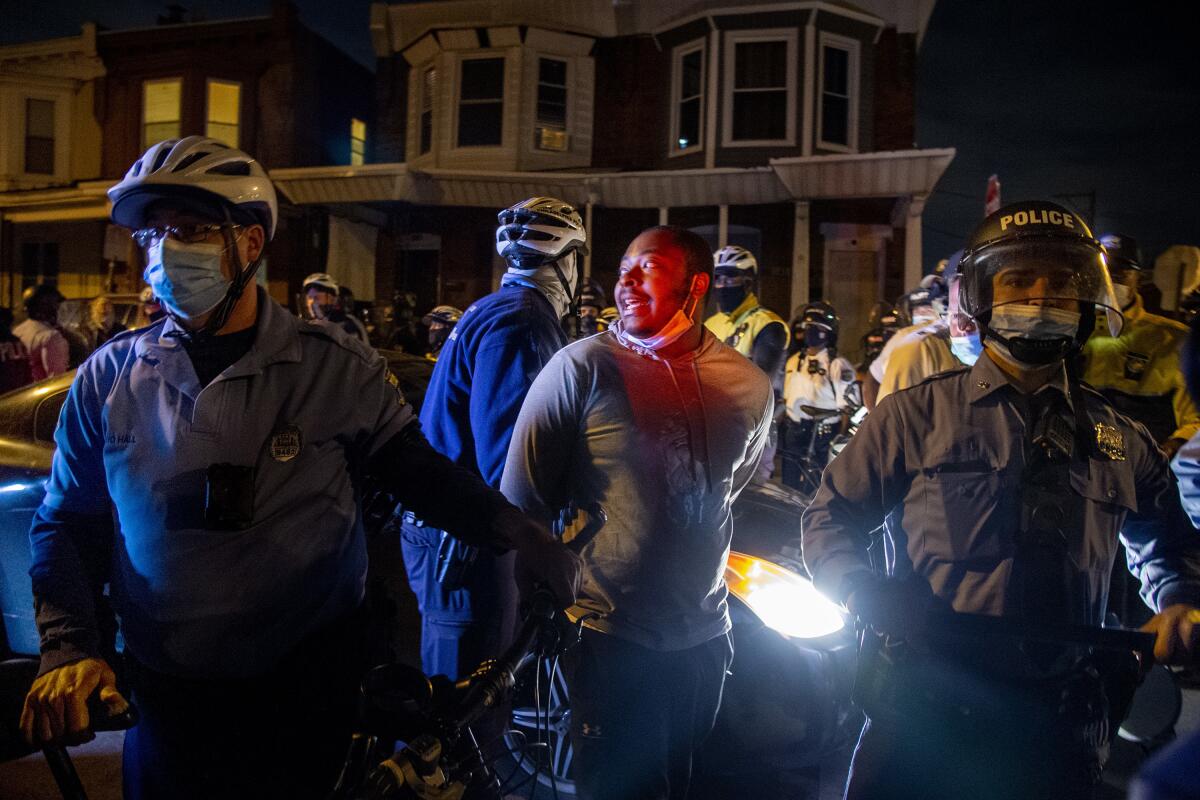 A person is handcuffed and detained by police in Philadelphia Oct. 28 