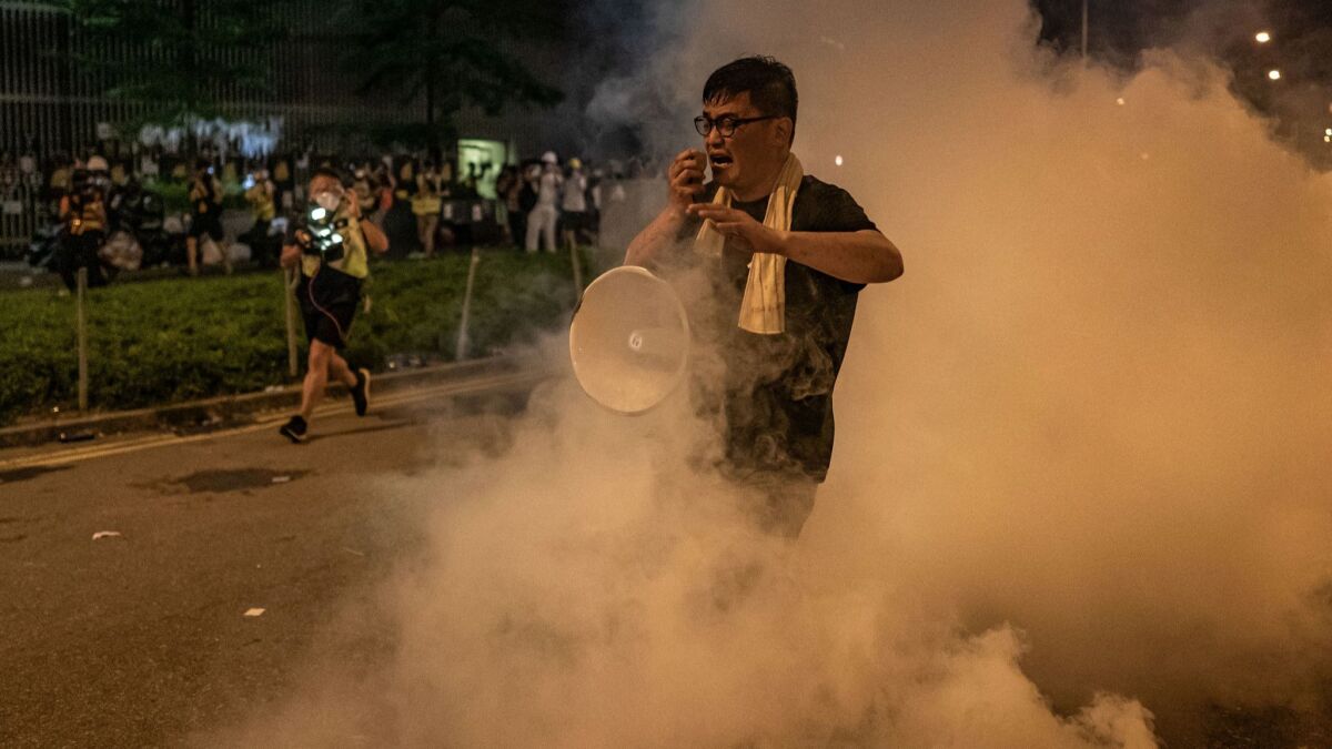 A protester reacts after police fire tear gas outside the Legislative Council complex on July 2, 2019, in Hong Kong.