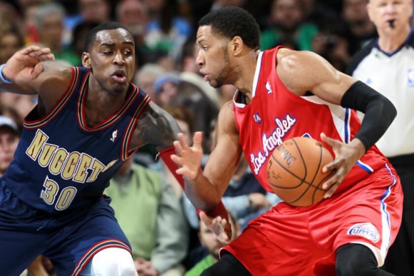 The Clippers' Danny Granger drives against the Nuggets' Quincy Miller during a game in Denver.