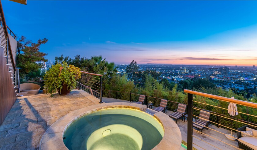 The hillside home includes three levels of decks, balconies and patios, as well as a swimming pool and spa.