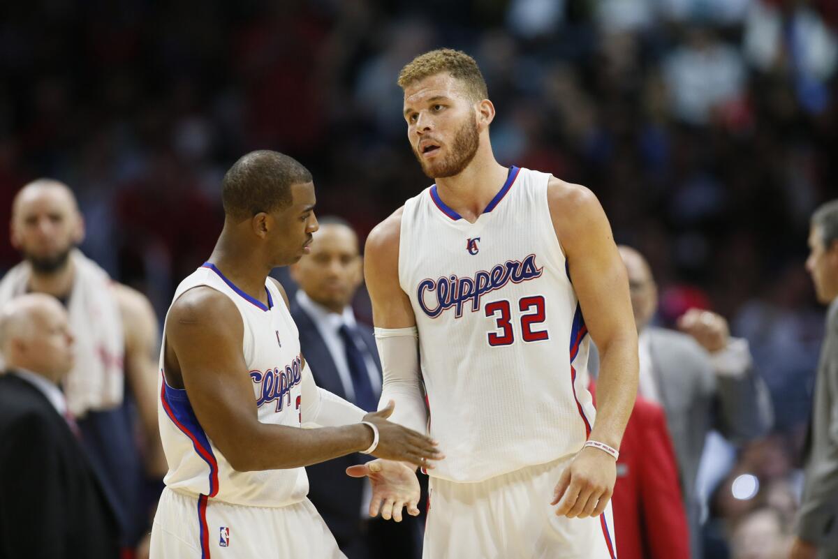 Clippers point guard Chris Paul and power forward Blake Griffin slap hands during the Clippers 113-99 win over the Wizards.
