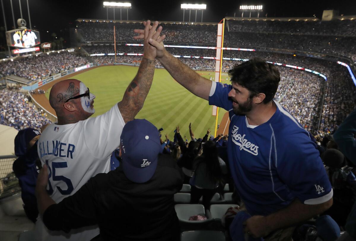 Fans celebrate as the Dodgers beat the Astros 3-1 in Game 6 of World Series at Dodger Stadium on Oct. 31, 2017. 