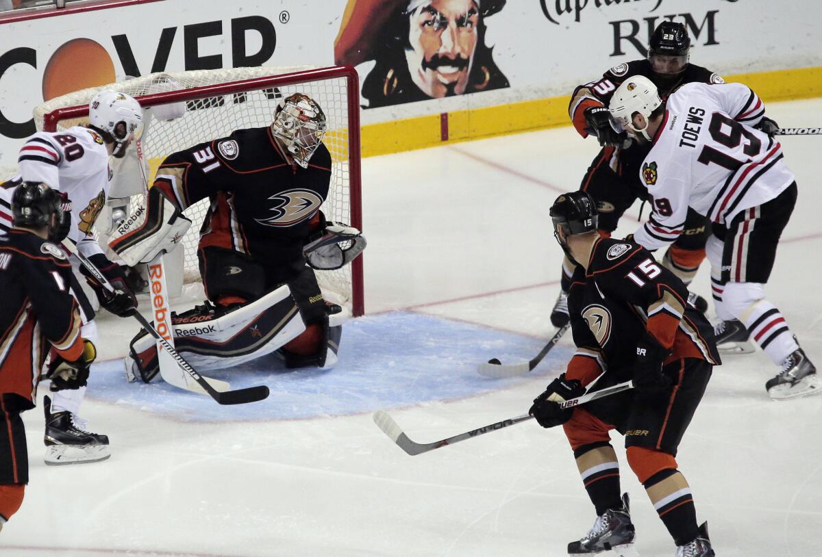 Blackhawks center Jonathan Toews (19) collects a rebound and scores against Ducks goalie Frederik Andersen to open the scoring in the first period of Game 7.