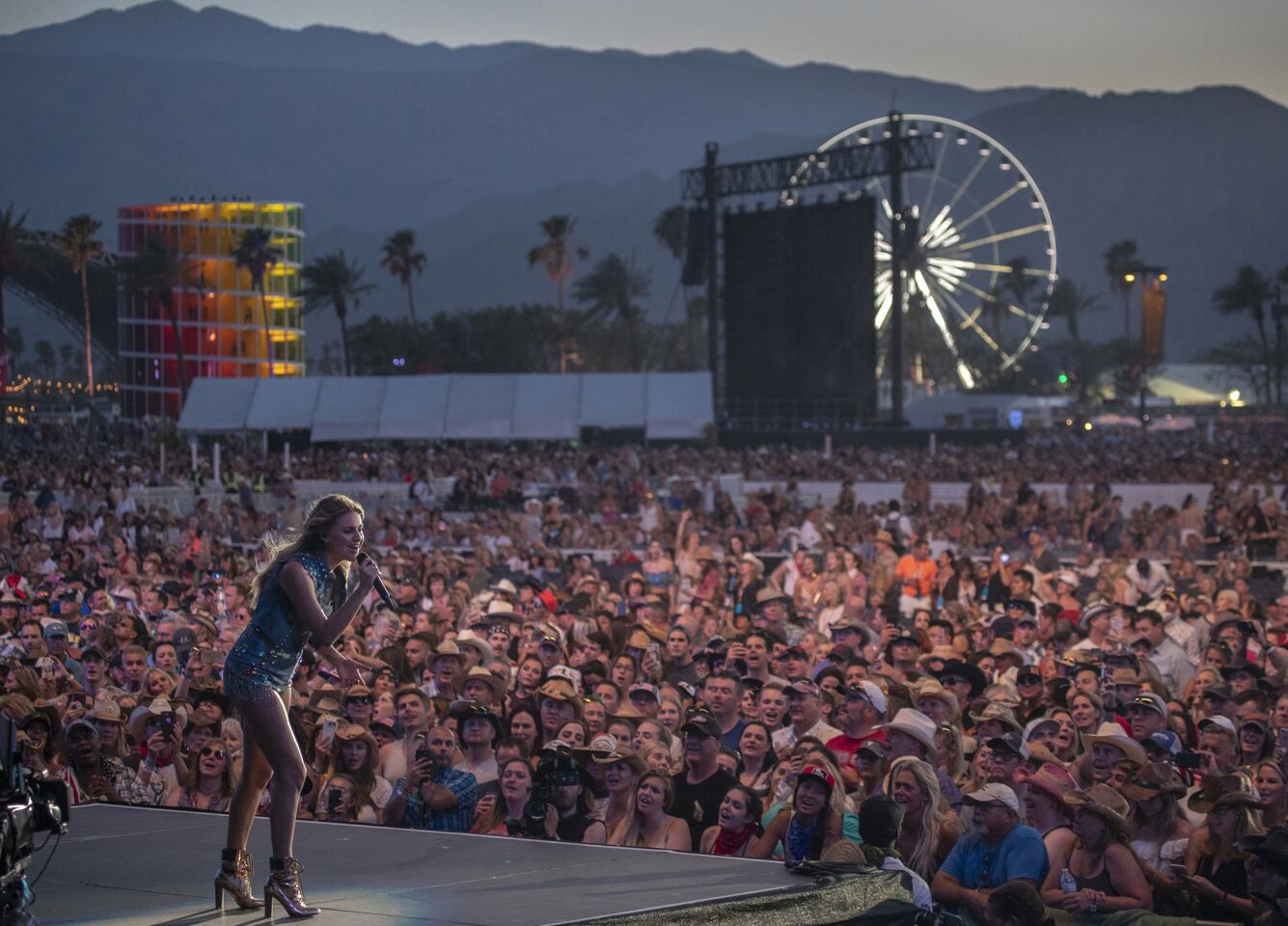 Kelsea Ballerini performs in front of a sea of fans.