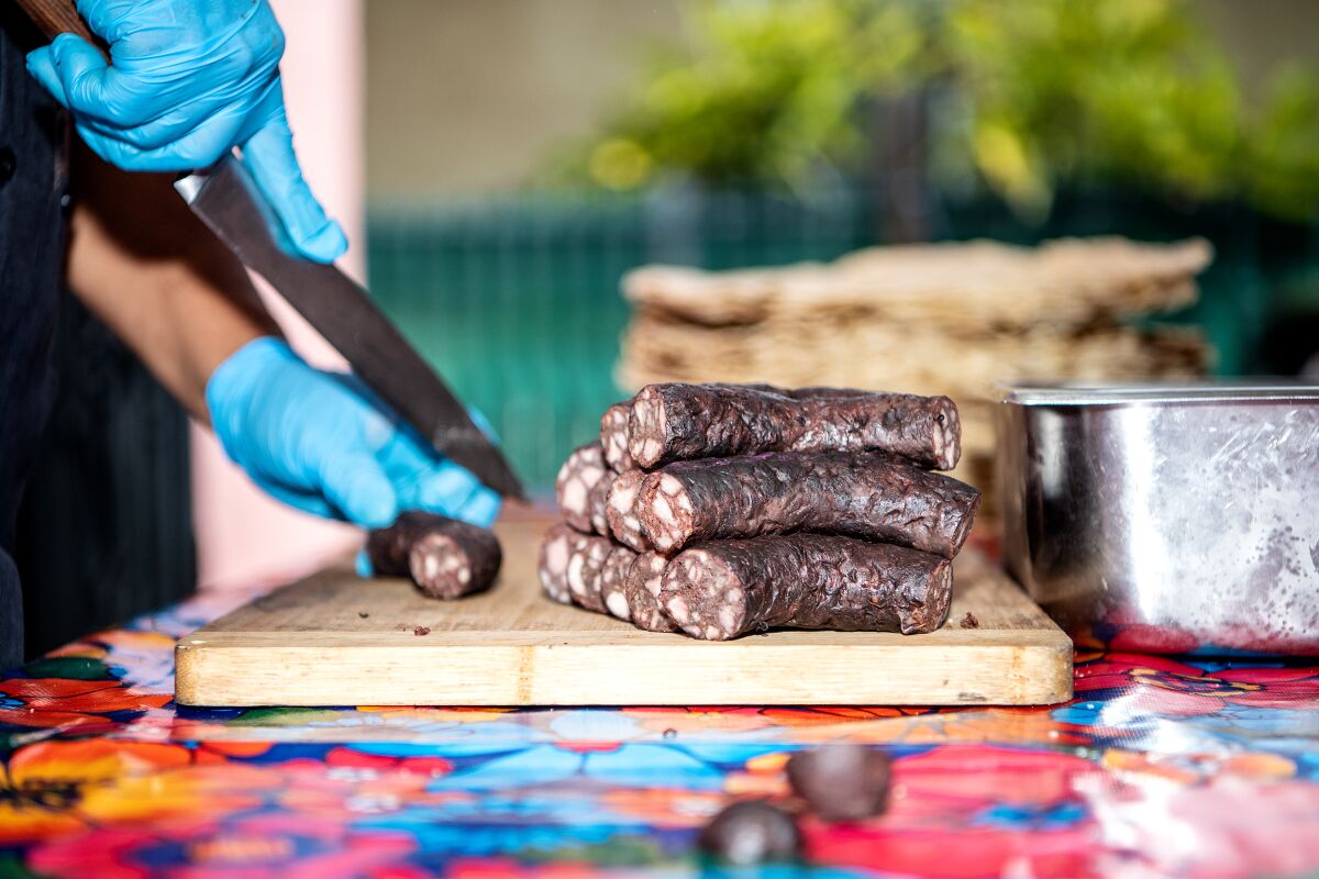 Alfonso "Poncho" Martinez makes his tlayudas and blood sausage dish at his home.