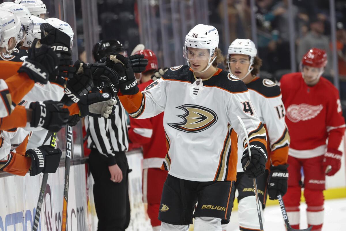 Ducks forward Trevor Zegras is congratulated as he returns to the bench after scoring against Detroit.