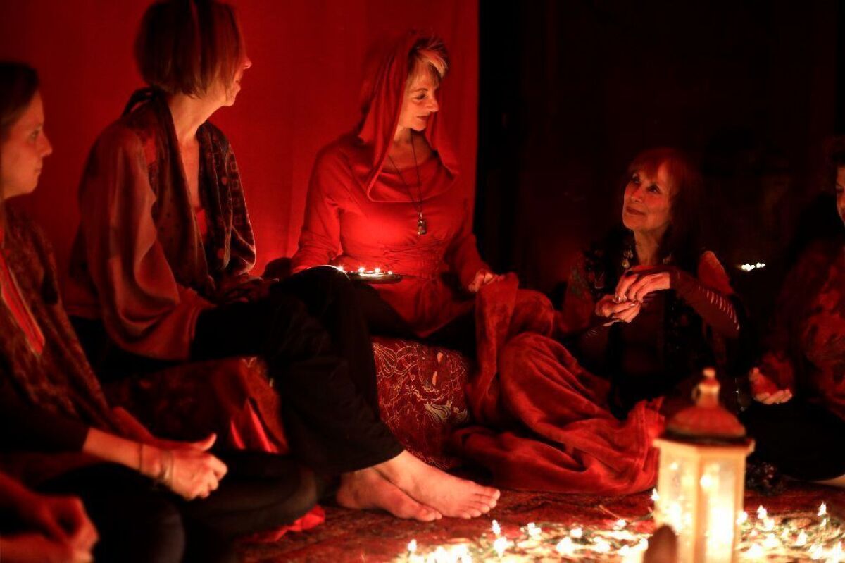 Among those gathered for a Red Tent event in March were Joy White Peacock Woman, second from left, and Elisa "Wowza" Lodge, right.