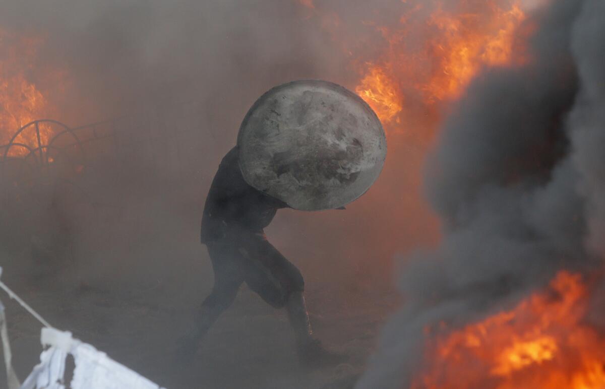A protester is shown during a clash with riot police Saturday in Kiev, Ukraine.