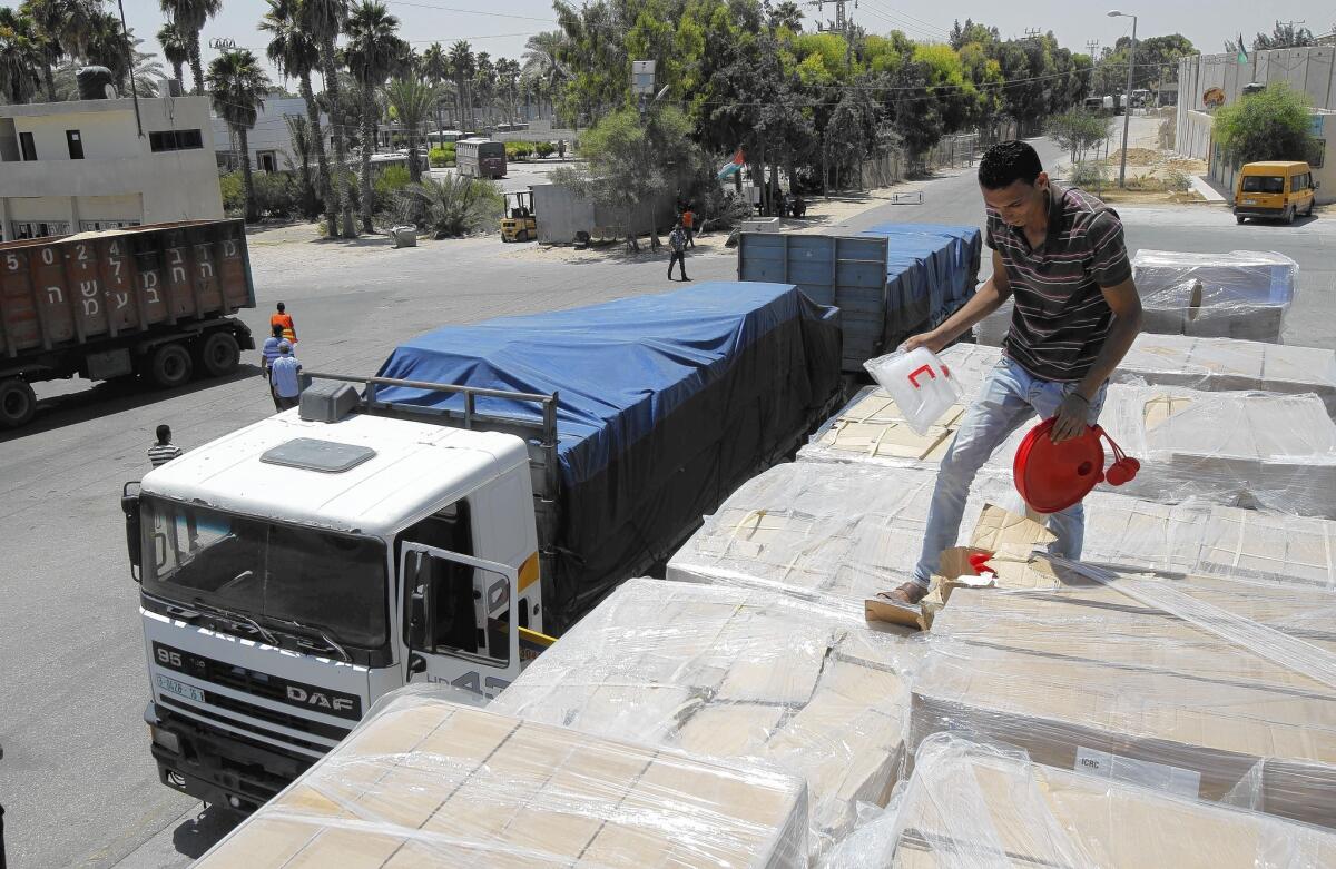 Trucks carrying humanitarian aid arrive in Rafah, in the Gaza Strip. Israelis and Palestinians were holding indirect talks in Cairo to try to extend a cease-fire.