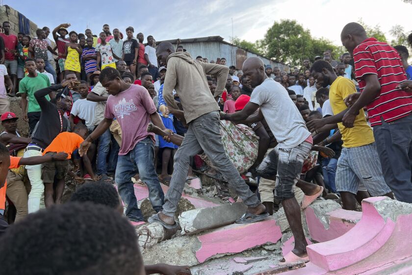 Varias personas ayudan a una persona herida después de que una casa se derrumbó debido a un sismo en Jeremie, Haití, el 6 de junio de 2023. (AP Foto/Ralph Simon)