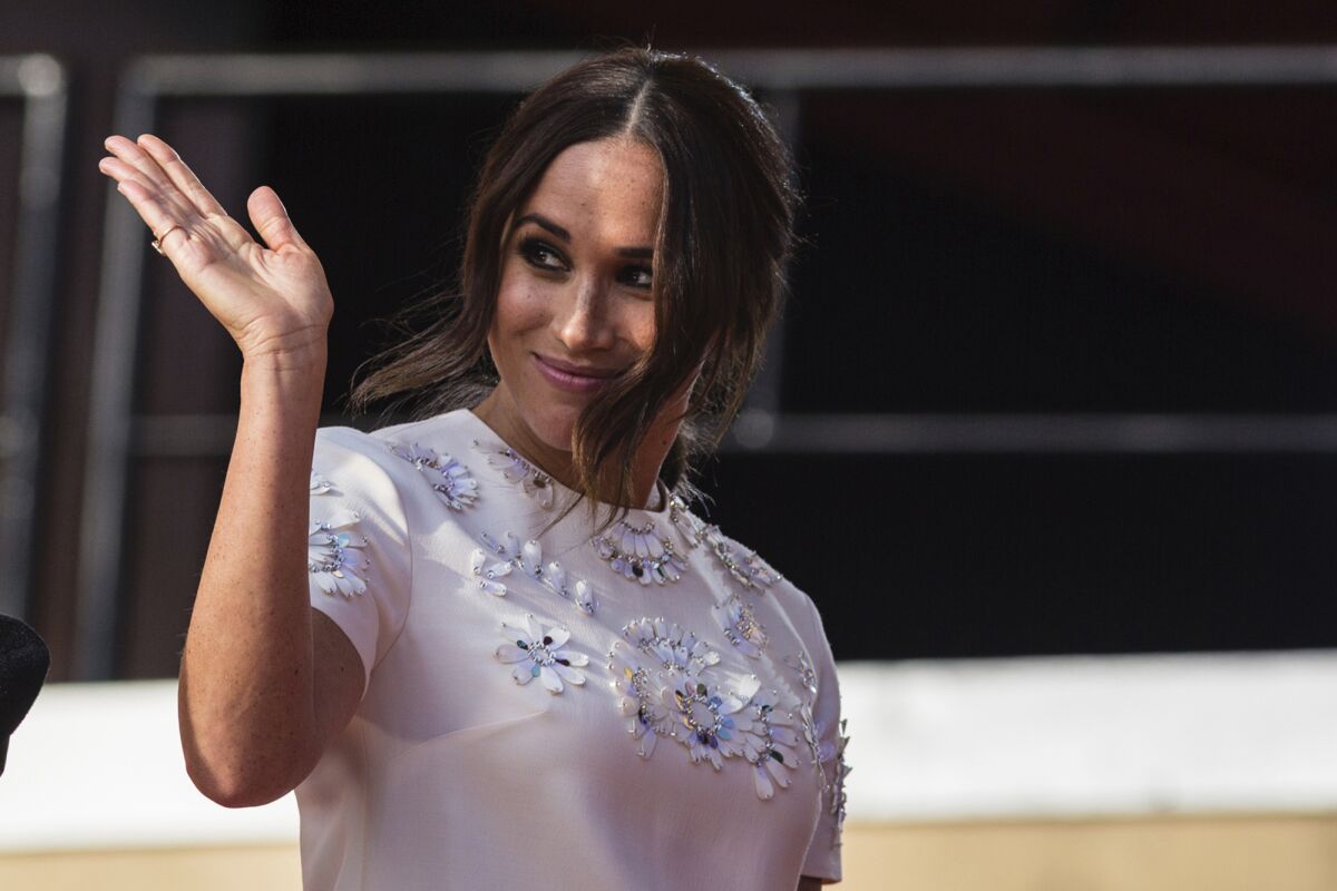 FILE - Meghan Markle, Duchess of Sussex, salutes during the Global Citizen festival, on Sept. 25, 2021 in New York. A British newspaper publisher began Tuesday its court appeal against a judge's ruling that it invaded the privacy of the Duchess of Sussex by publishing parts of a letter she wrote to her estranged father, arguing that she knew the letter would potentially be published. (AP Photo/Stefan Jeremiah)