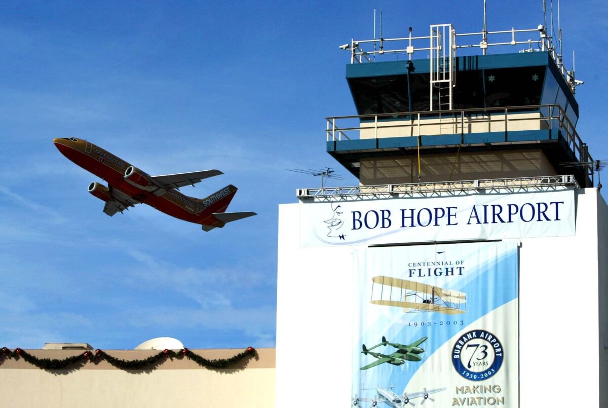 A Southwest airplane takes off over the tower at Bob Hope Airport in Burbank.