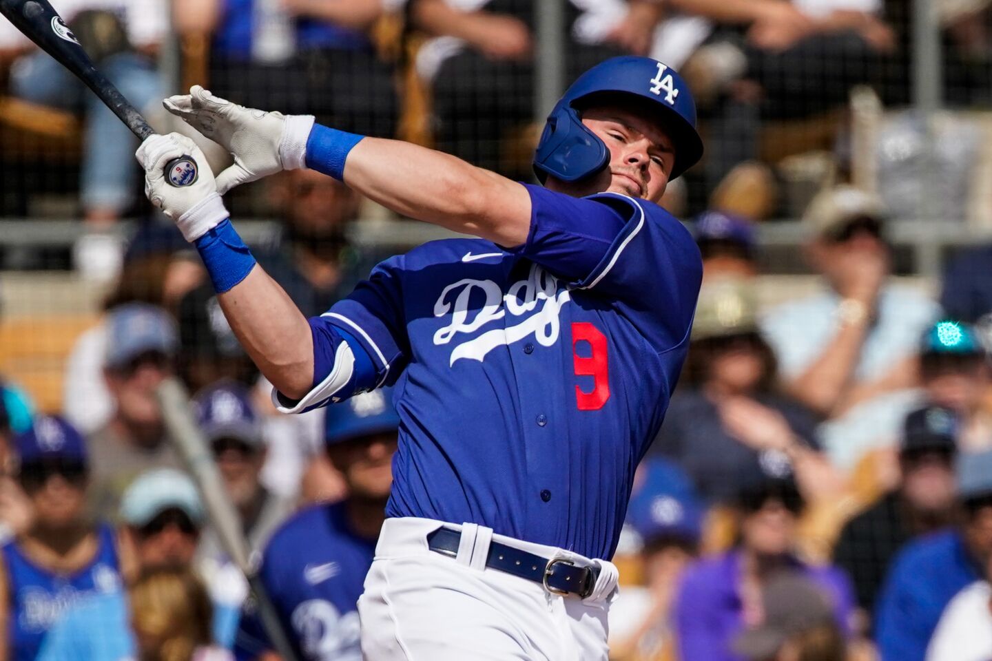 Dodgers shortstop Gavin Lux swings at a pitch during a spring training exhibition game against the Chicago Cubs on Feb. 23, 2020.