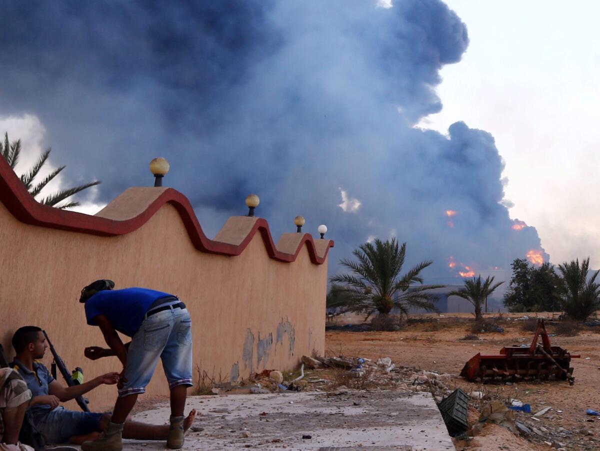 Smoke rises from Tripoli's main fuel depot after it was struck by rockets fired by Islamist militiamen.