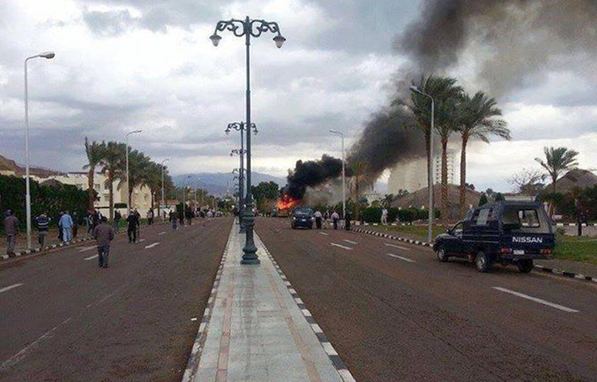 Smoke billows from the site of a bomb explosion that targeted a tourist bus in the Egyptian south Sinai resort town of Taba.