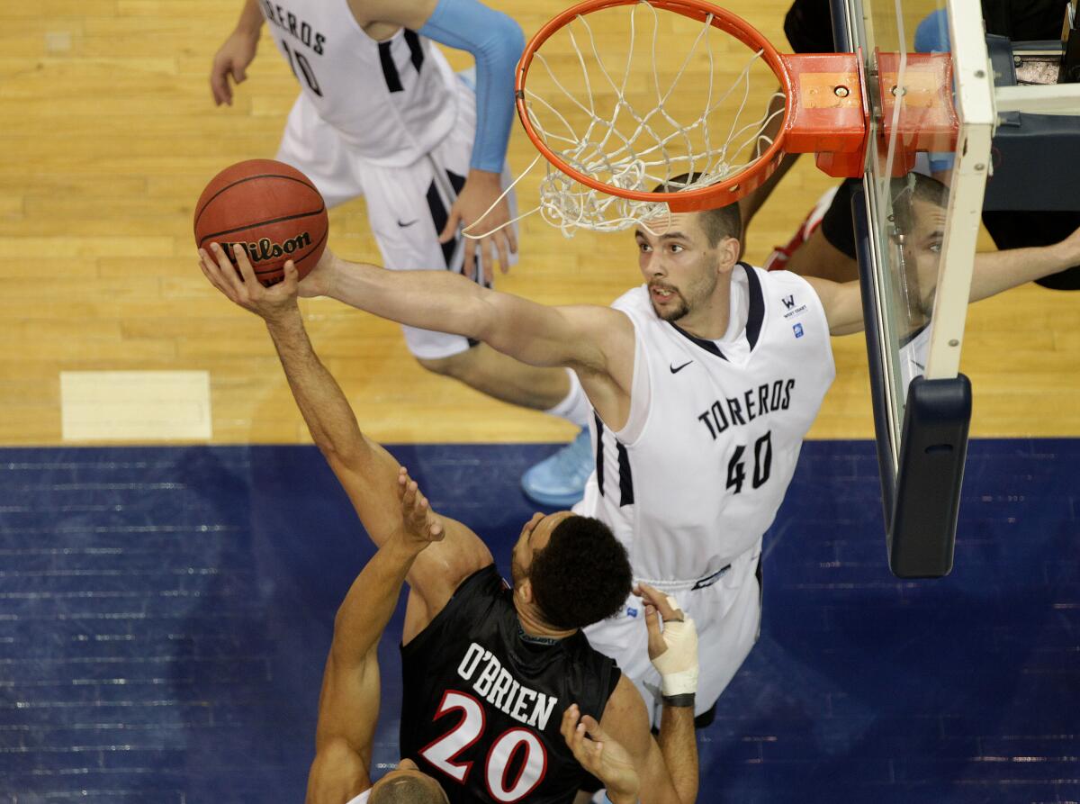 Dennis Kramer lunges for a rebound during a December 2013 game against San Diego State at the Jenny Craig Pavilion.