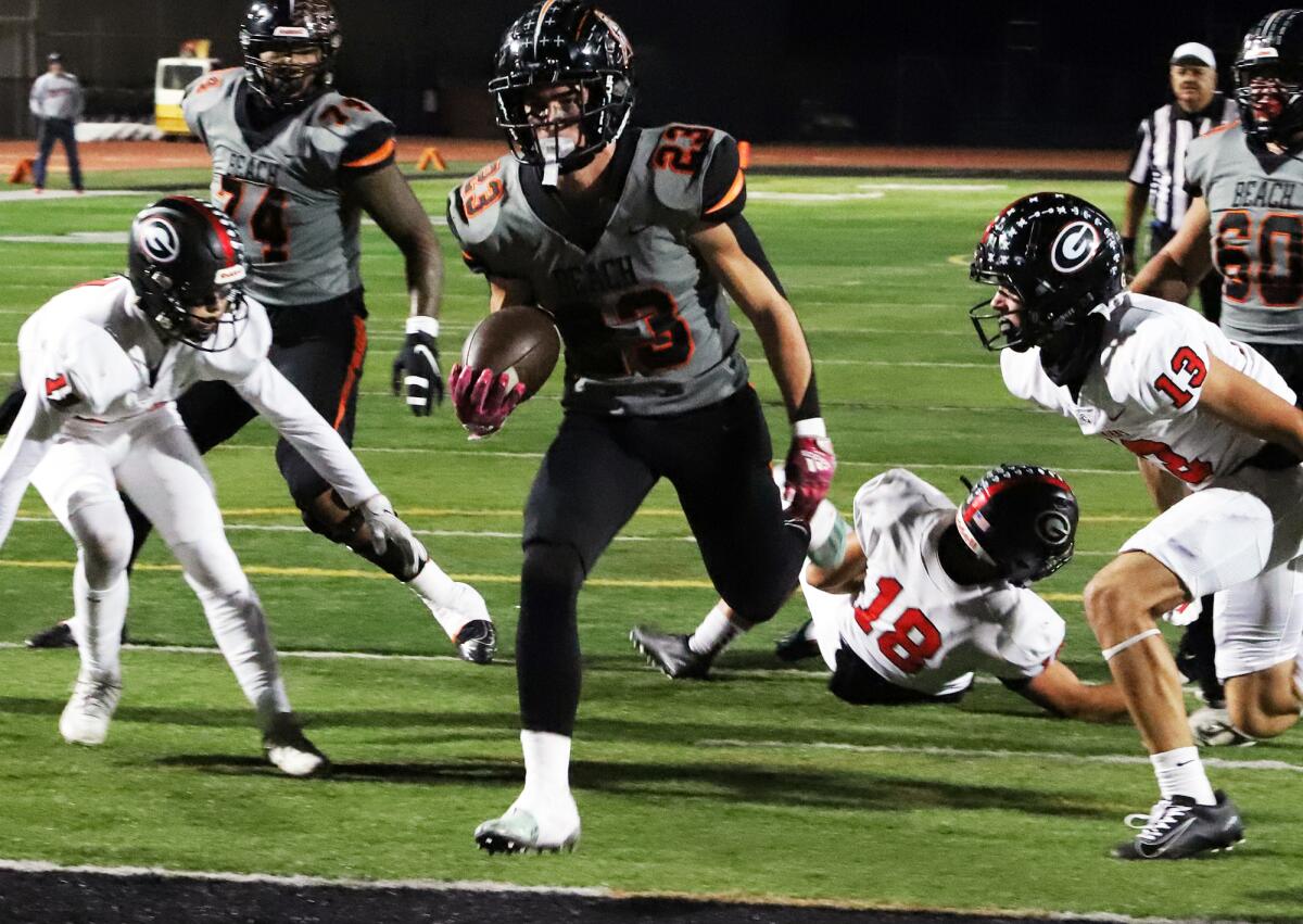 Huntington Beach's Tyler Young (23) runs in for a touchdown against Glendora on Friday.