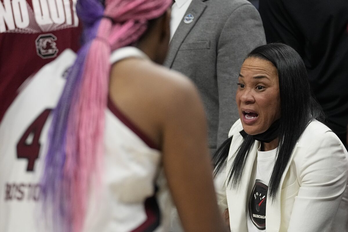 South Carolina head coach Dawn Staley talks to players during the first half of a college basketball game in the semifinal round of the Women's Final Four NCAA tournament Friday, April 1, 2022, in Minneapolis. (AP Photo/Eric Gay)
