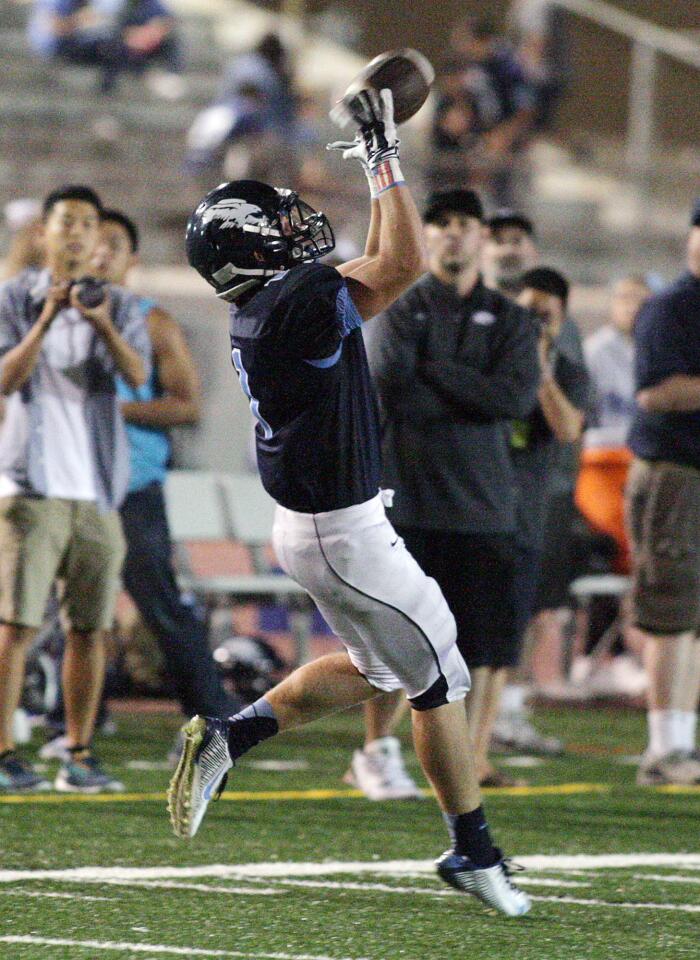 Crescenta Valley's Chase Walker falls a little backward to make a huge catch late in the second quarter for a lot of yards in the the second quarter against Verdugo Hills in a non-league football game at Glendale High School in Glendale on Thursday, September 4, 2014. The catch put the team in scoring position.