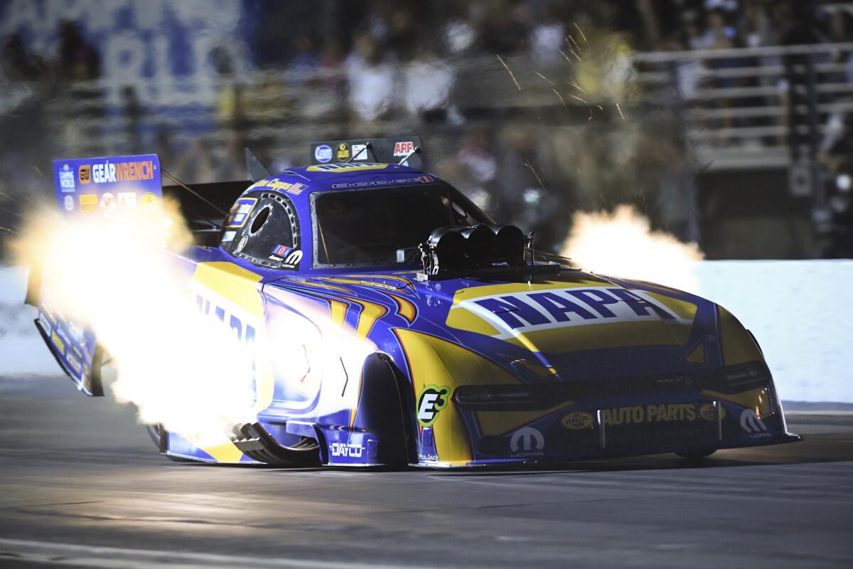 In this photo provided by the NHRA, Ron Capps drives in Funny Car qualifying.