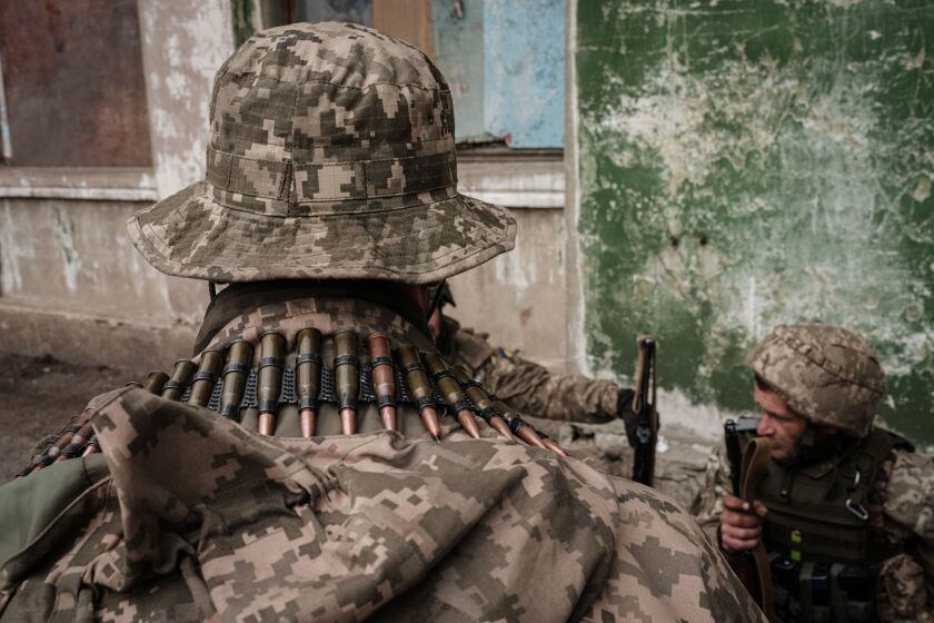 Ukrainian soldiers arrive at an abandoned building to rest and receive medical treatment.