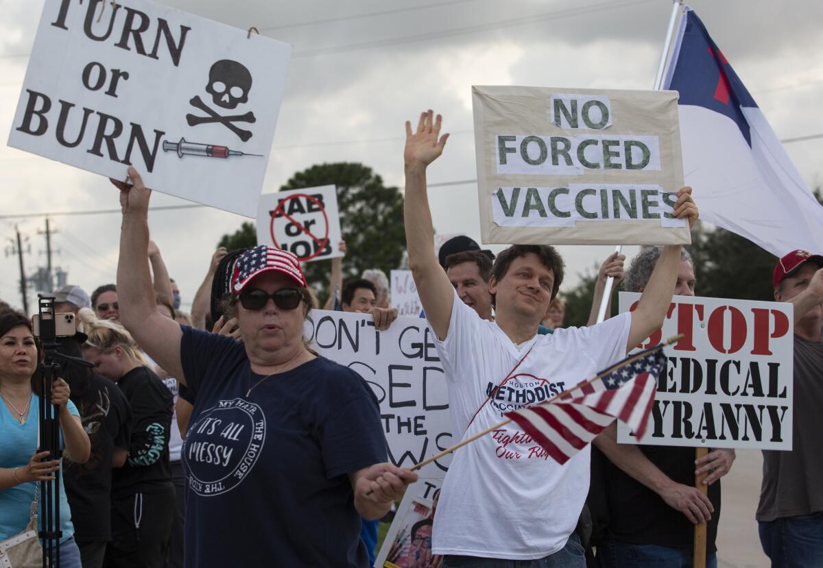 Demonstrators in Baytown, Tex., protest against Houston Methodist’s COVID-19 vaccine mandate. 
