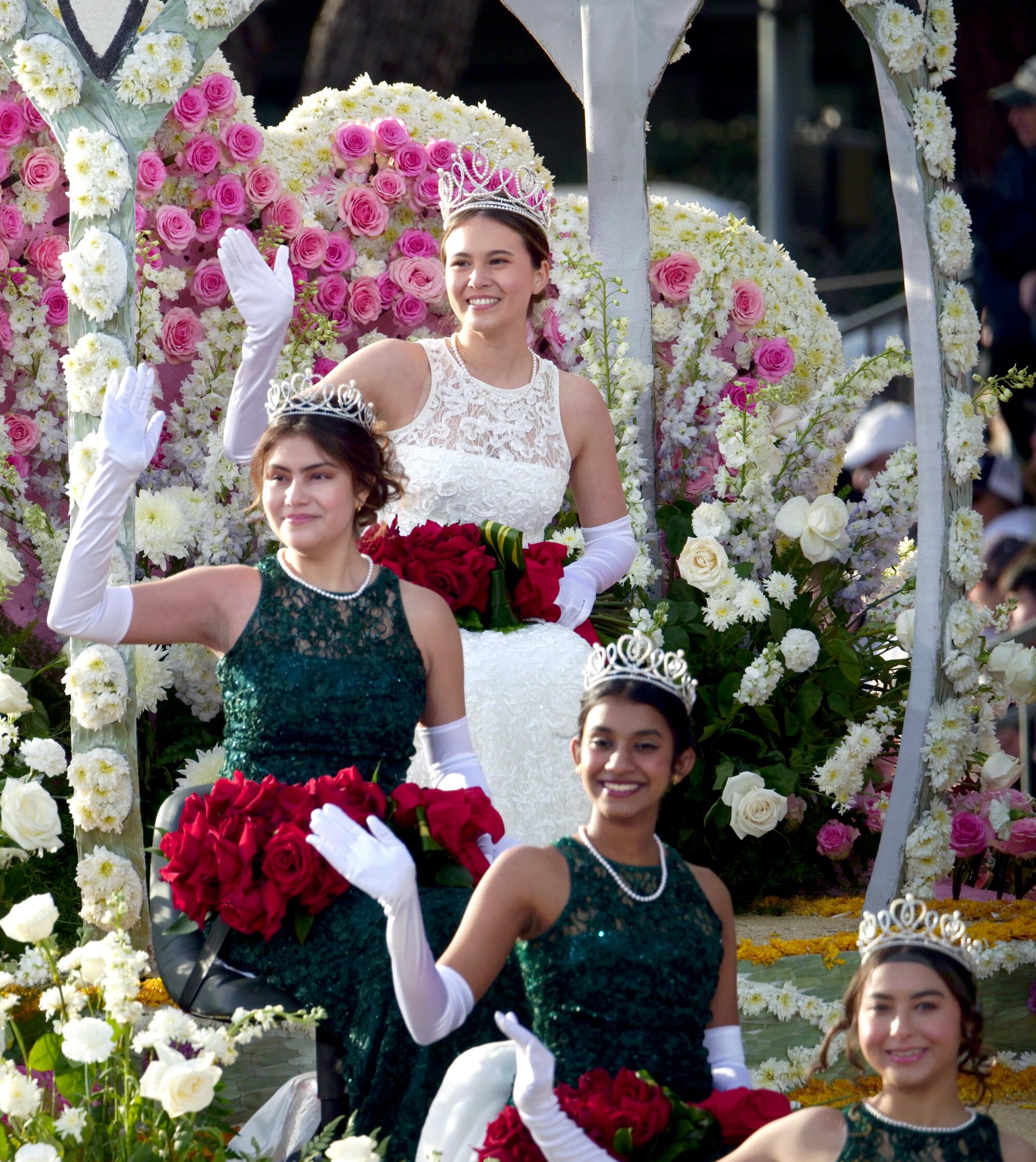 The 2023 Rose Queen and three members of her court wave from a float.