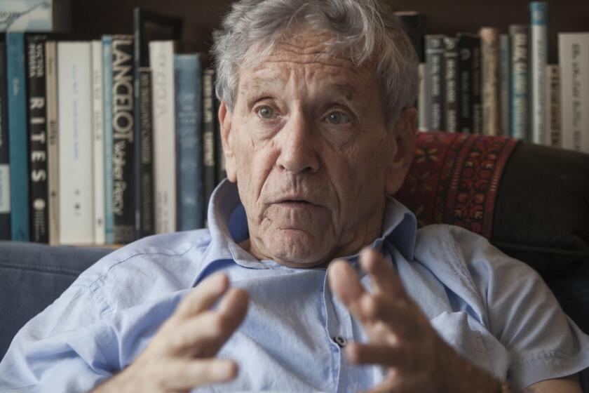 FILE - In this Nov. 4, 2015 file photo, Israeli writer Amos Oz poses for a photo at his house in Tel Aviv, Israel. Israeli media said Friday, Dec. 28, 2018 that renowned Israeli author Amos Oz has died at the age of 79. Oz, author of novels, prose and a widely acclaimed memoir, had suffered from cancer. Oz won numerous prizes, including the Israel Prize and Germanyâs Goethe Award, and was a perennial contender for the Nobel Prize in literature. (AP Photo/Dan Balilty, File)