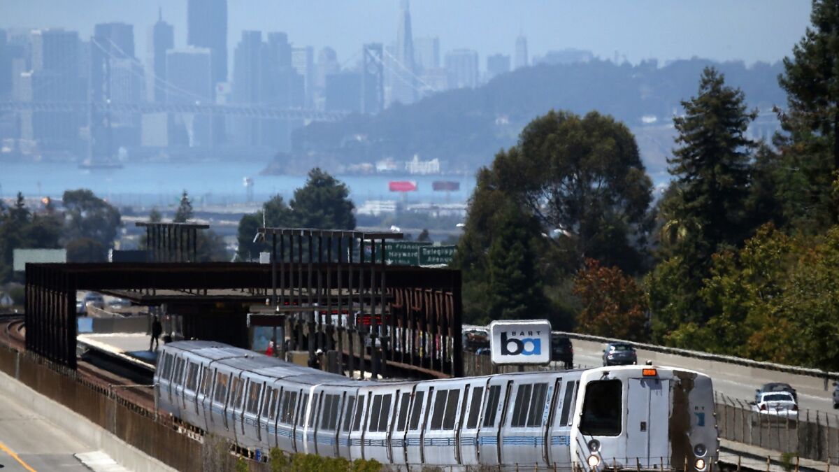 A Bay Area Rapid Transit train pulls away from the Rockridge station in Oakland. The transit district has been accused of using public resources to promote a bond measure.