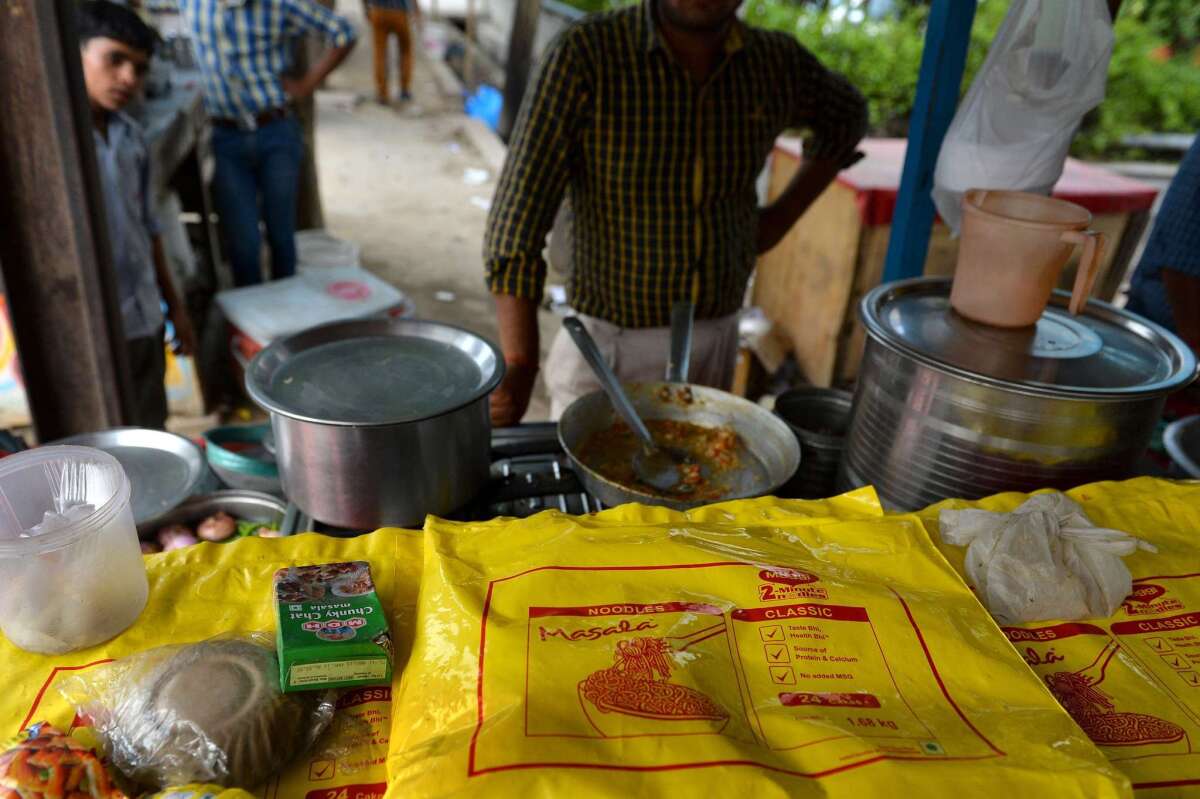 An Indian man prepares Nestle Maggi instant noodles at his roadside food stall on the outskirts of New Delhi.