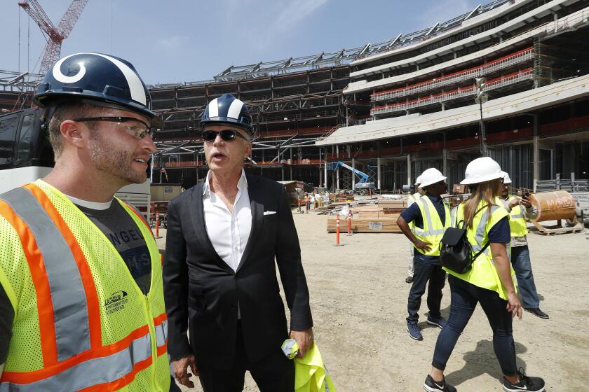 Rams head coach Sean Mcvay, left, talks with team owner Stan Kroenke during a tour of the Los Angeles Stadium at Hollywood Park in Inglewood.