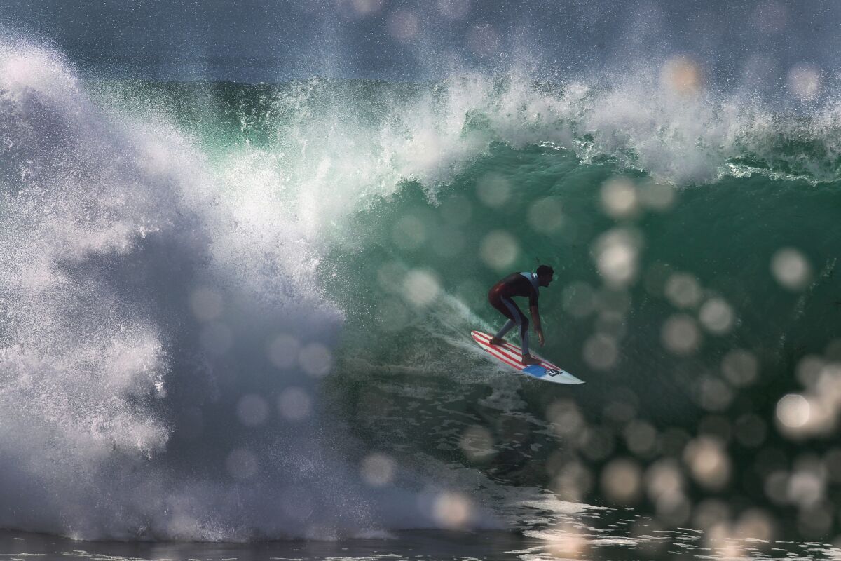 A surfer gets a tube ride at the Wedge in Newport Beach.