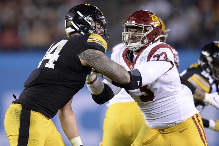 Iowa defensive end A.J. Epenesa (94) works against Southern California offensive tackle Austin Jackson (73) during the first half of the Holiday Bowl NCAA college football game Friday, Dec. 27, 2019, in San Diego. (AP Photo/Orlando Ramirez)