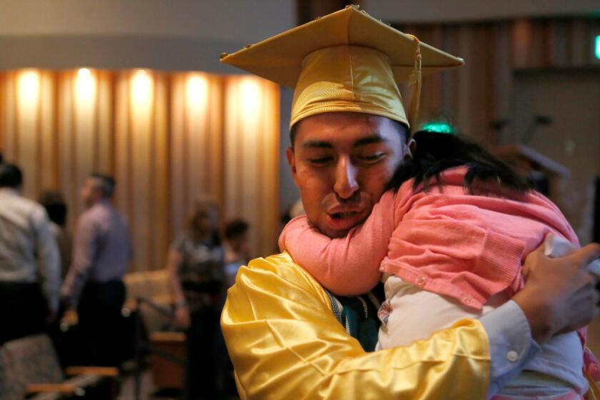 LOS ANGELES, CA. -- Friday, June 9, 2017 Bryan Pea, 18, hugs his younger sister after his high school graduation ceremony. (Christian K. Lee / Los Angeles Times)