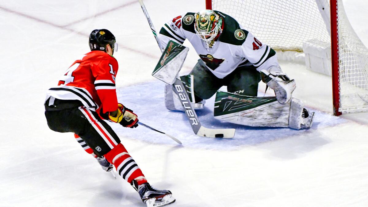 Wild goalie Devan Dubnyk stops a point-blank shot by Blackhawks left wing Richard Panik during the second period of their game Sunday.