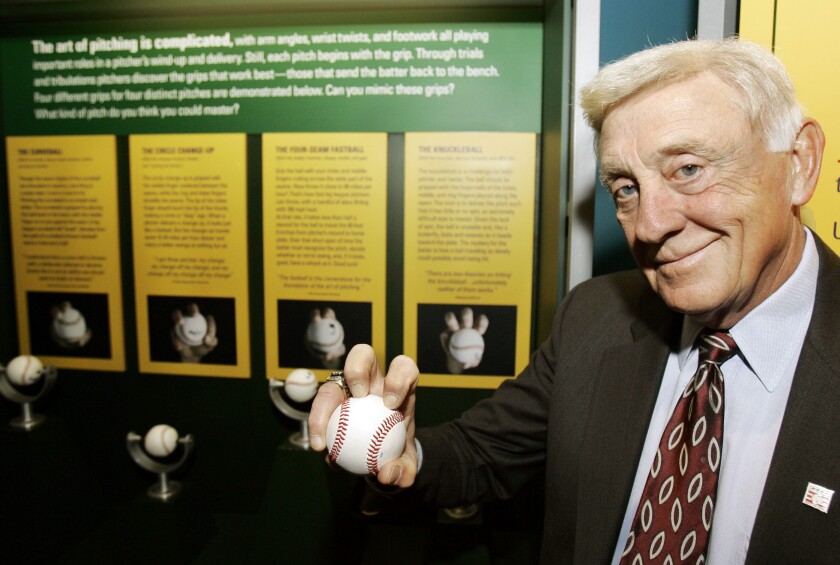 Baseball Hall of Famer Phil Niekro holds a knuckleball at the Great Lakes Science Center in Cleveland.