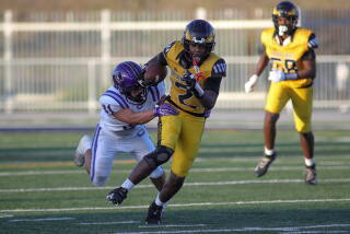 Jemari Holt of King/Drew picks up yards against Cathedral.
