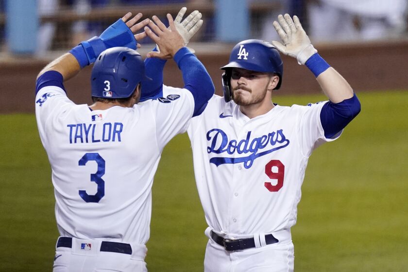 Los Angeles Dodgers' Gavin Lux, right, is congratulated by Chris Taylor after hitting a three-run home run.