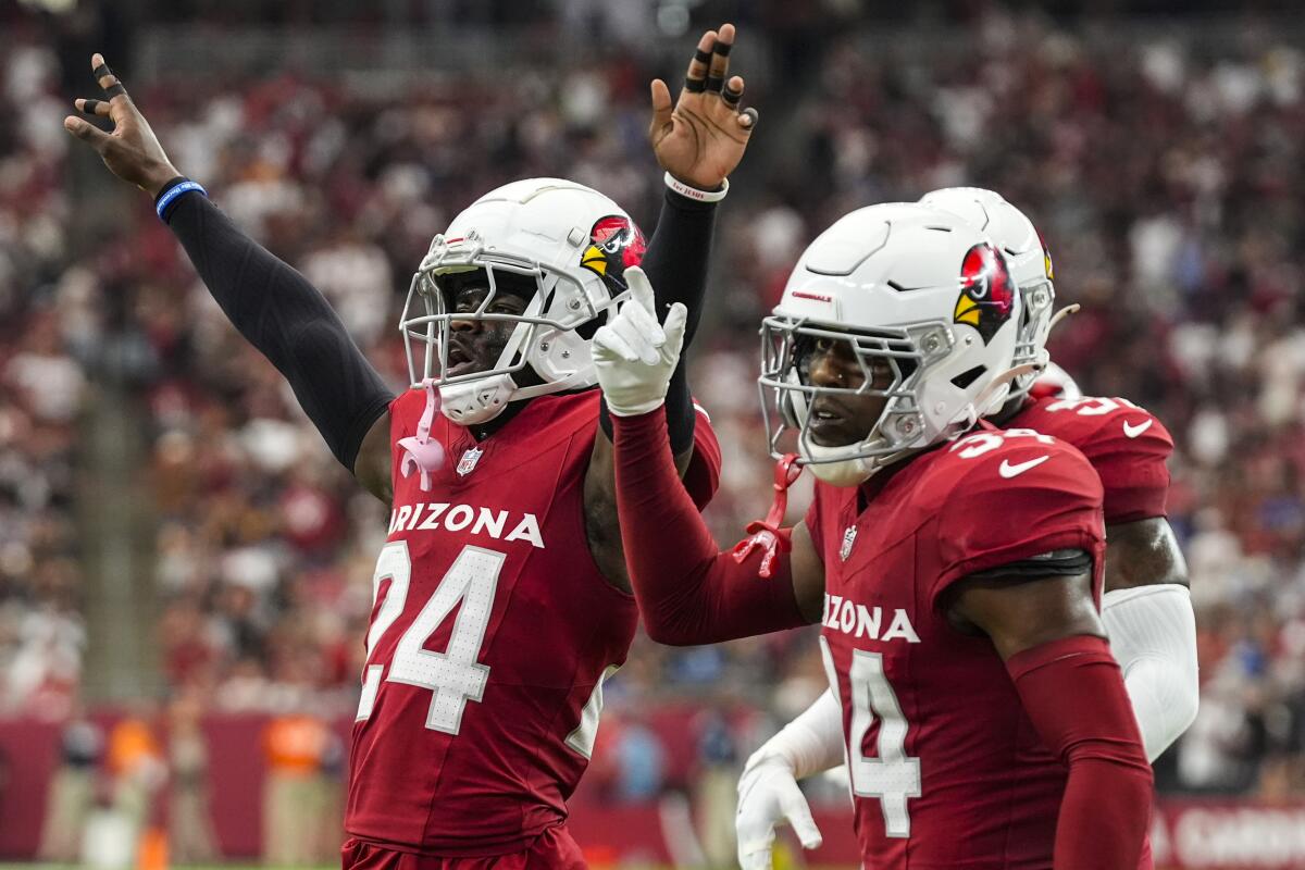 Arizona Cardinals cornerback Starling Thomas V, left, celebrates with teammates.