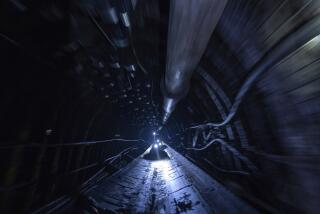 Miners ride on a conveyor in the tunnel at the coal mine in Dnipropetrovsk region, Ukraine, on Friday, April 7, 2023. (AP Photo/Evgeniy Maloletka)