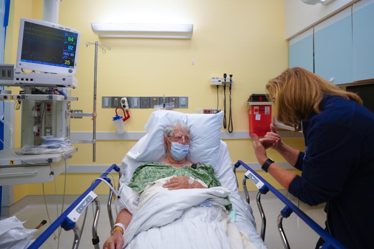 Elderly ER patient meets with nurse at Sharp Grossmont Hospital on March 30, 2021.