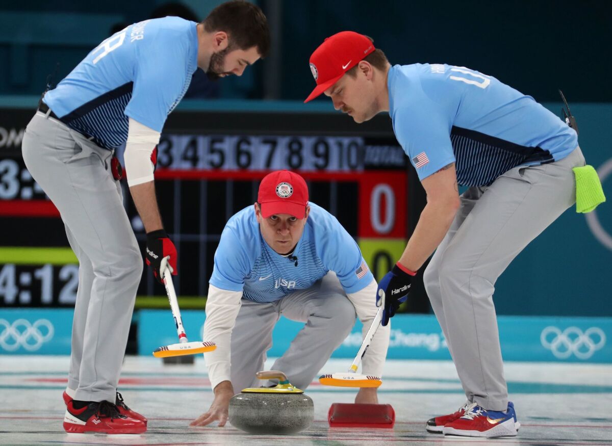 John Shuster, center, John Landsteiner, left, and Matt Hamilton of the U.S. during the men's curling final.
