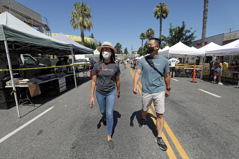 STUDIO CITY, CA - AUGUST 02: Siblings Carol and Phillip Kwan own Mama Musubi in Pasadena. Their business is affected by the county public health rule mandating that vendors that prepare food onsite at farmers markets can't operate during the pandemic. They haven't been able to sell food at the Studio City Farmers Market nor at four other farmers markets since about late March. Photographed at Studio City Farmers Market on Sunday, Aug. 2, 2020 in Studio City, CA. (Myung J. Chun / Los Angeles Times)