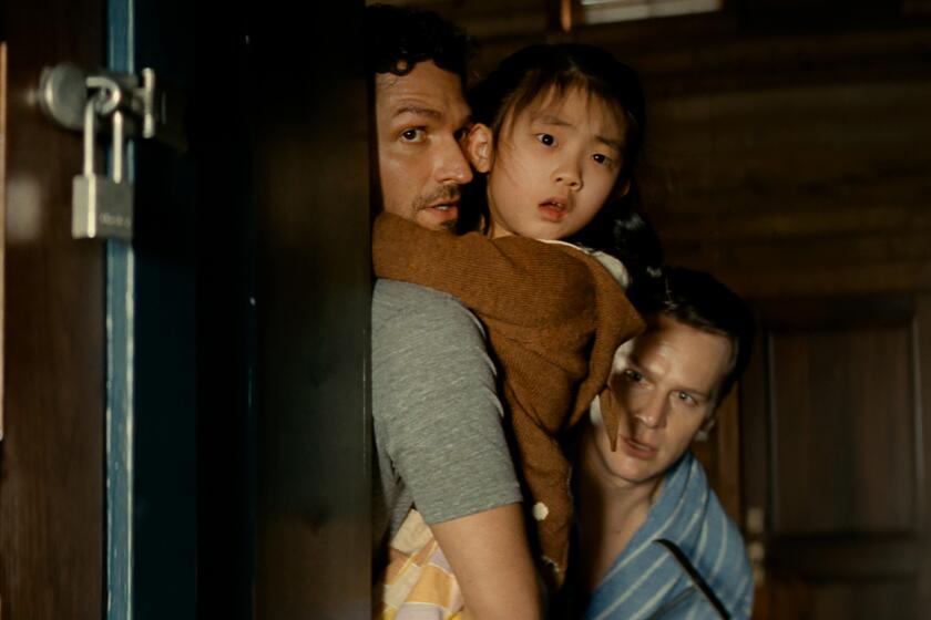 (from left) Ben Aldridge, Kristen Cui, and Jonathan Groff in KNOCK AT THE CABIN.