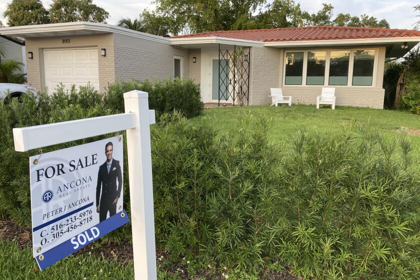 FILE - A home with a "Sold" sign is shown, Sunday, May 2, 2021, in Surfside, Fla. Homebuyers are regaining leverage at the negotiating table as the housing market slows, new data from Redfin shows. On average, U.S. homes purchased during a four-week period in August 2022 sold for less than the asking price. (AP Photo/Wilfredo Lee, File)