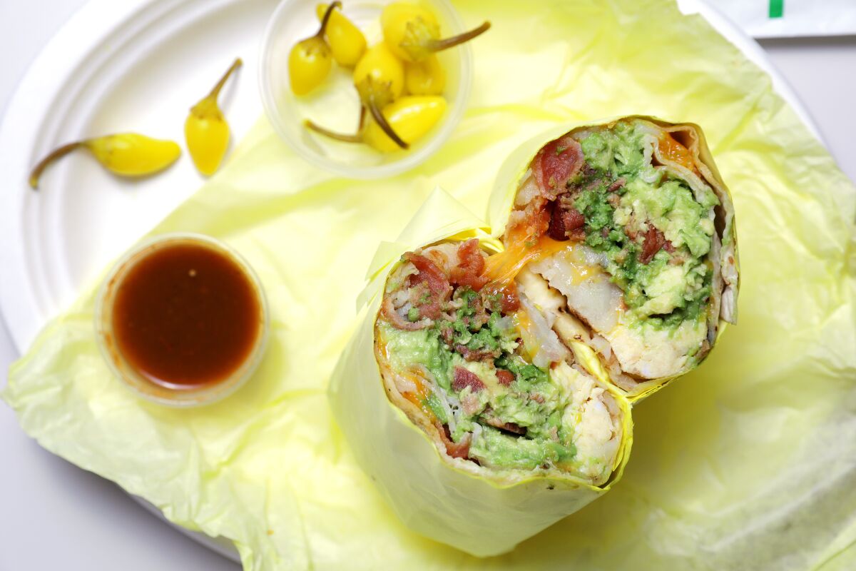 A breakfast burrito with bacon and avocado from Lucky Boy