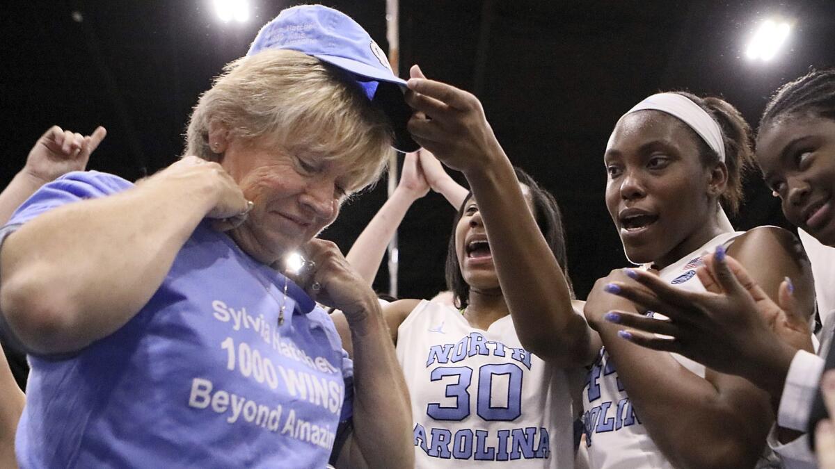 North Carolina coach Sylvia Hatchell is greeted by her players Dec. 19, 2017, after her 1,00th career coaching victory.