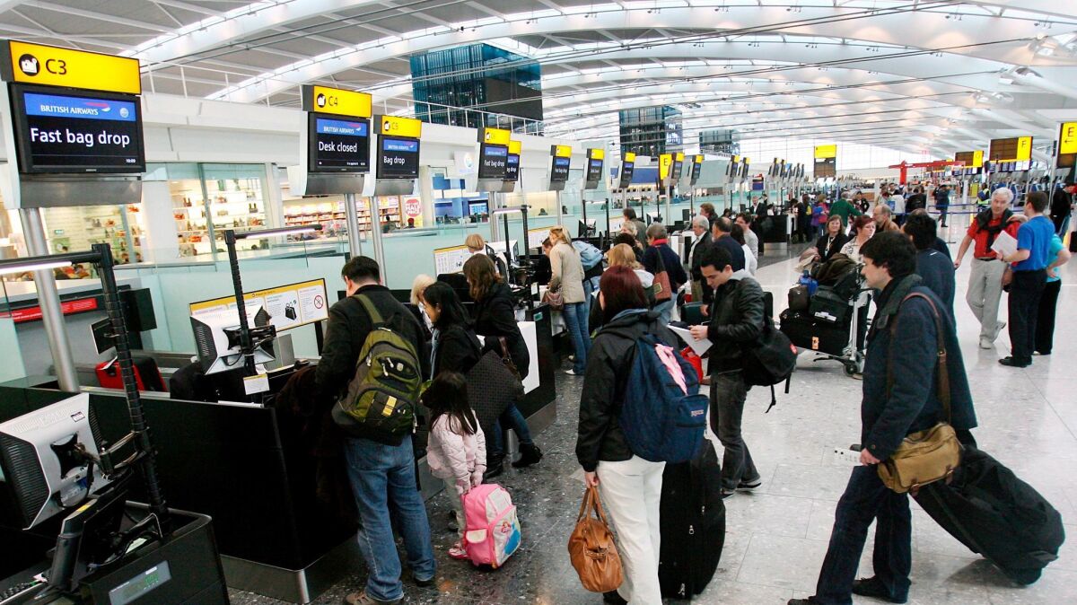 British Airways customers check in at Heathrow Airport's Terminal 5 in London. A service called Heathrow VIP inspired the private terminal at Los Angeles International Airport. (Andy Rain / European Pressphoto Agency)