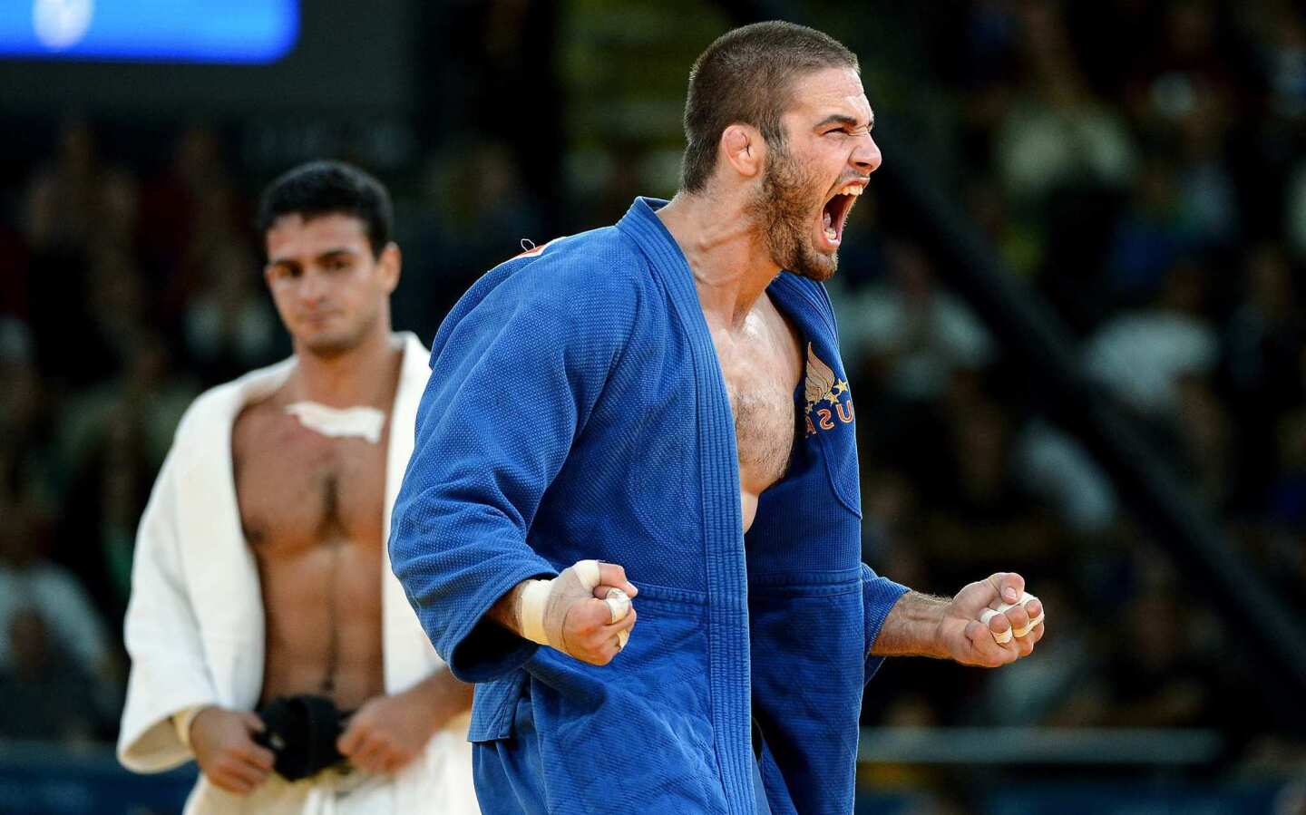 Travis Stevens celebrates after defeating Brazil's Leandro Guilheiro, the top seed, to advance to the semifinals in the 81kg judo competition. Stevens went on to lose in the bronze medal match.